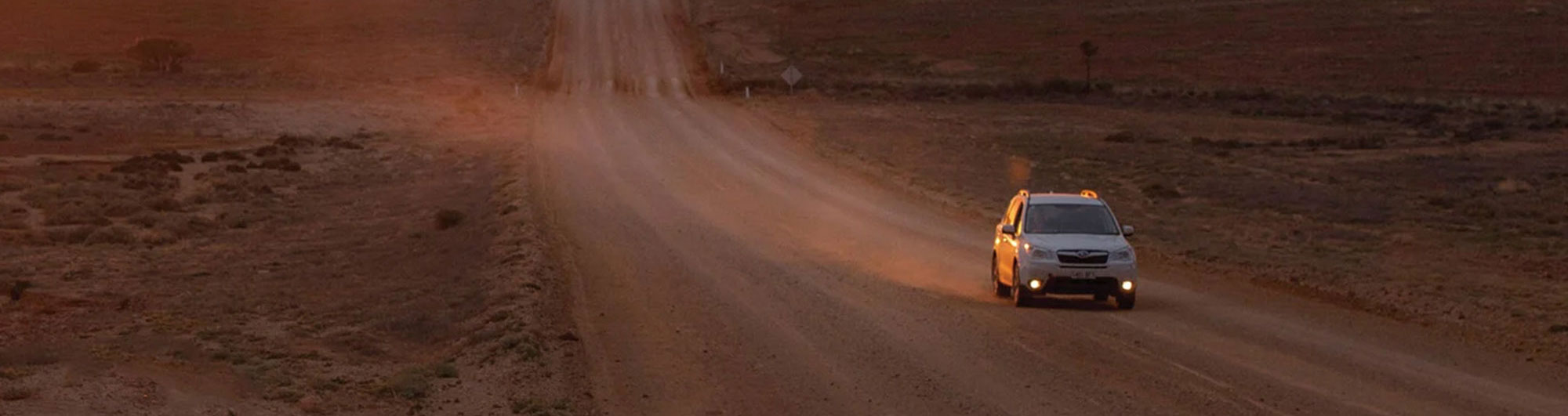 White car on a dirt road