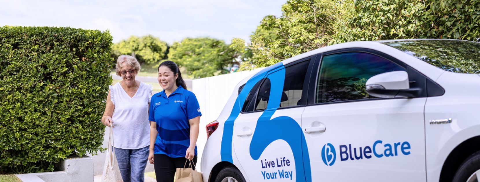 bluecare employee carry groceries from car
