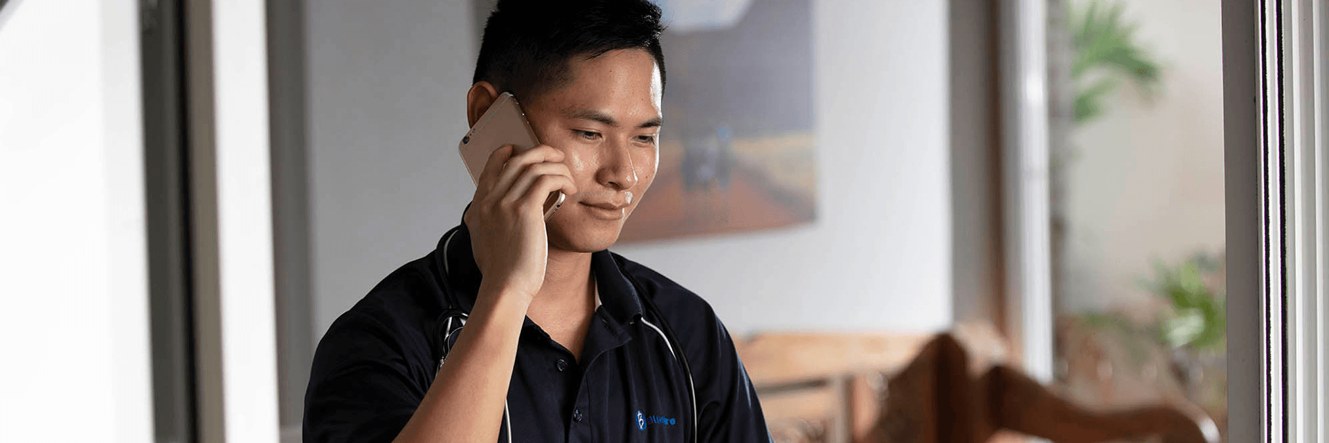 Blue Care carer talking on mobile phone
