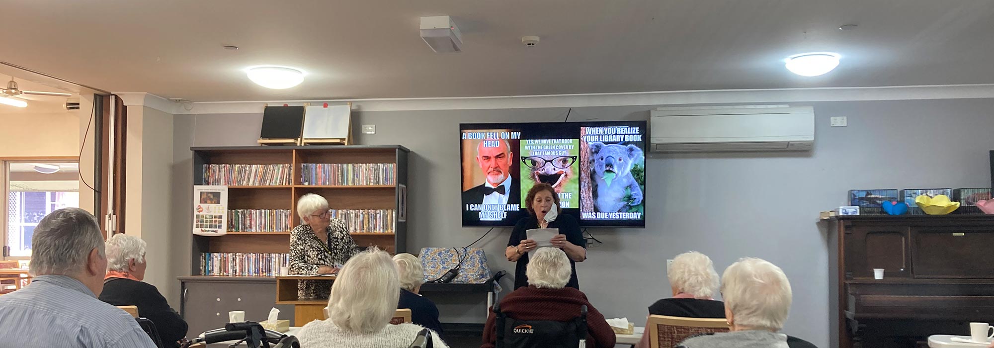Residents of Blue Care Yurana Aged Care listening to a live song performance