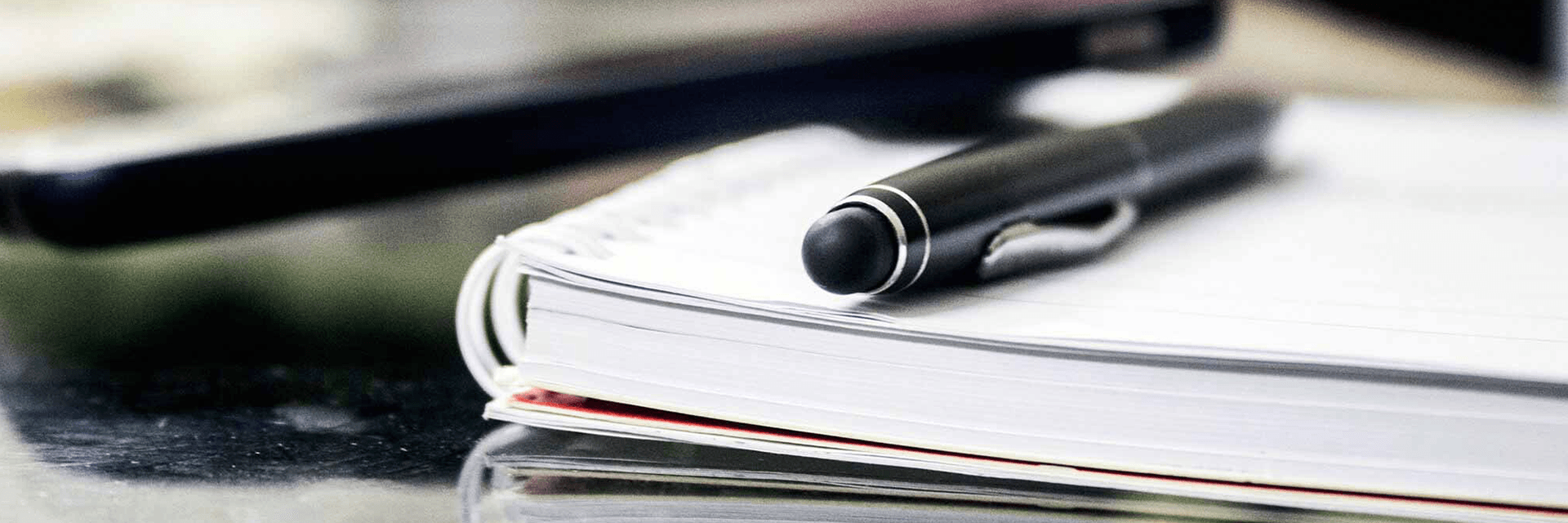 Close-up of a pen on top of an open book