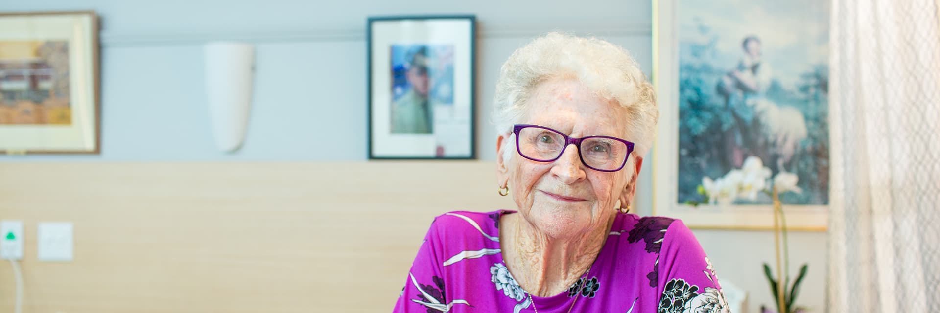 Blue Care residental care client Dorothy smiles at camera