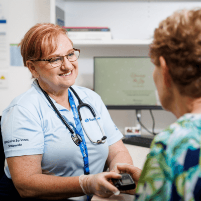 BlueCare staff member talking to client