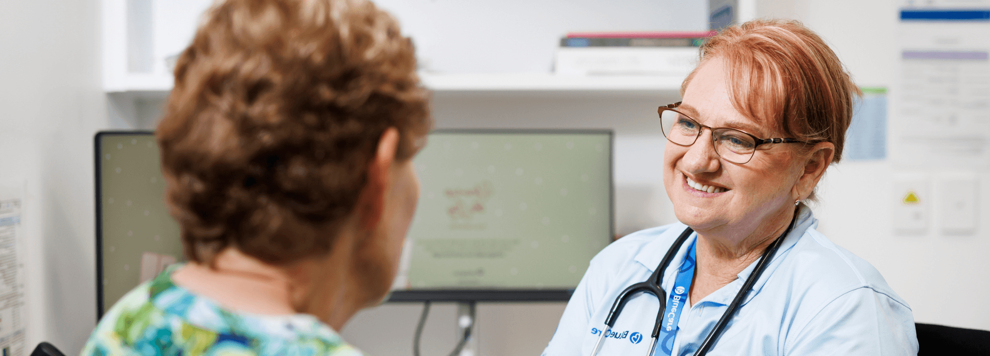 Bluecare staff member talking to client