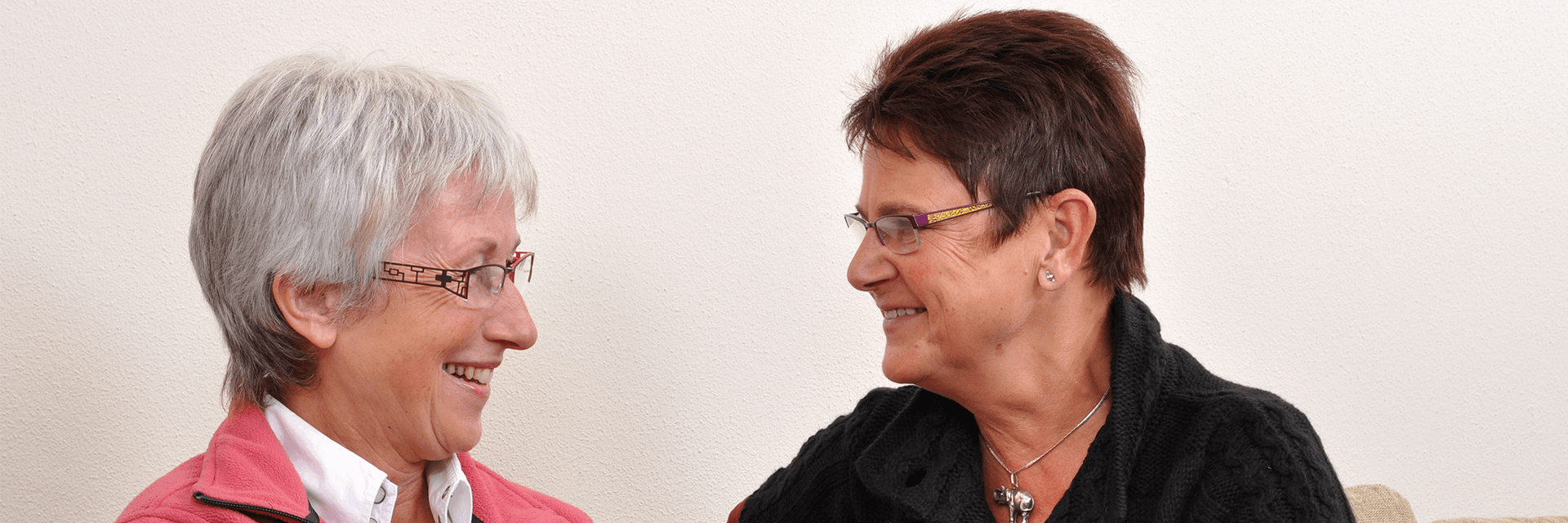 Two older ladies enjoy eachother's company