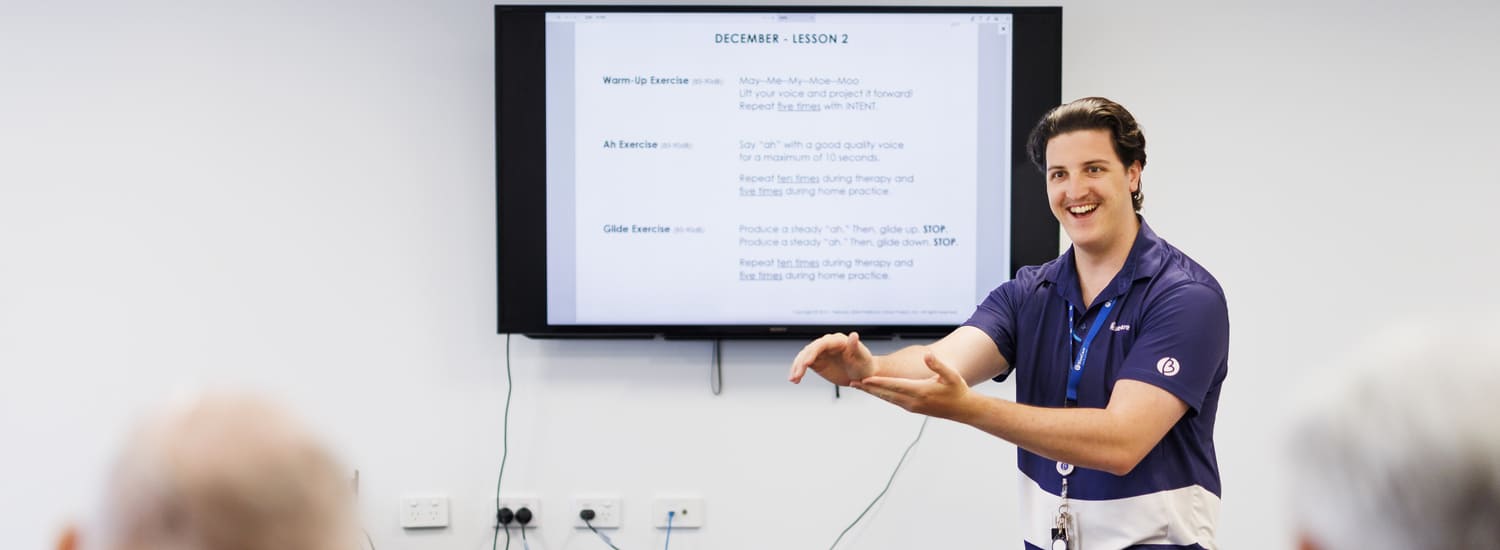 A BlueCare employee presenting something