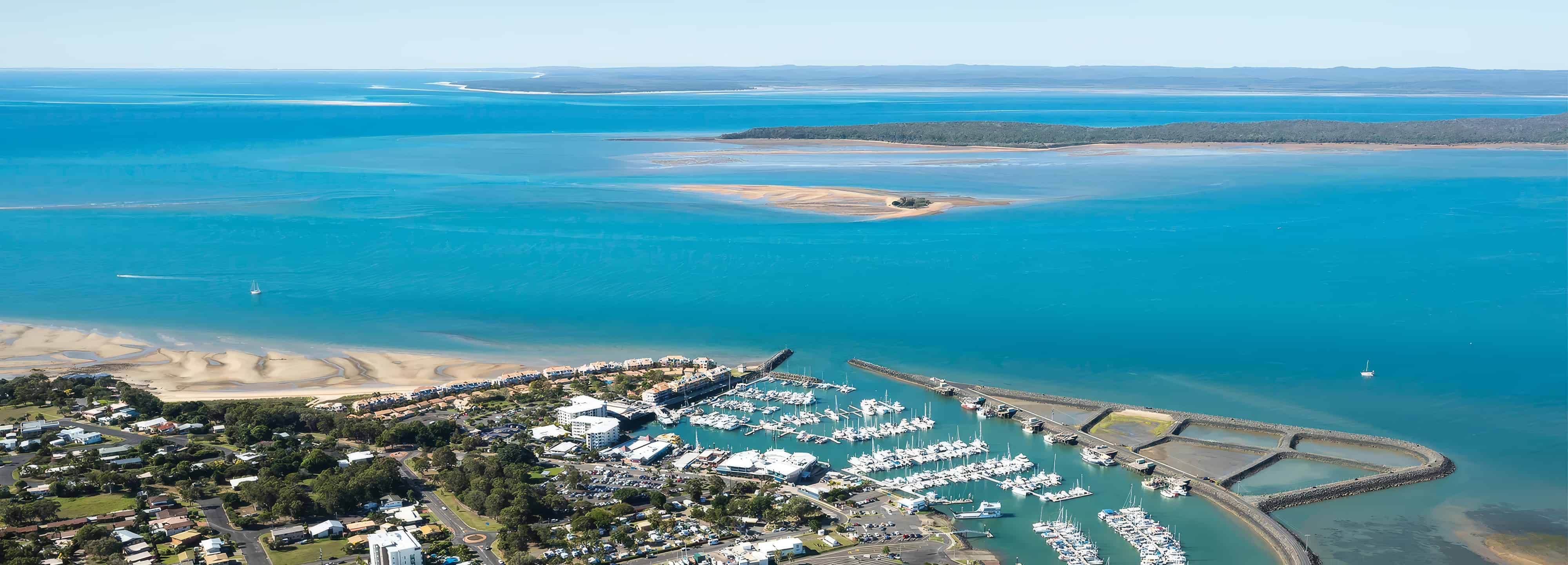 Aerial photo of the marina looking out to the water and islands off the coast of Hervey Bay