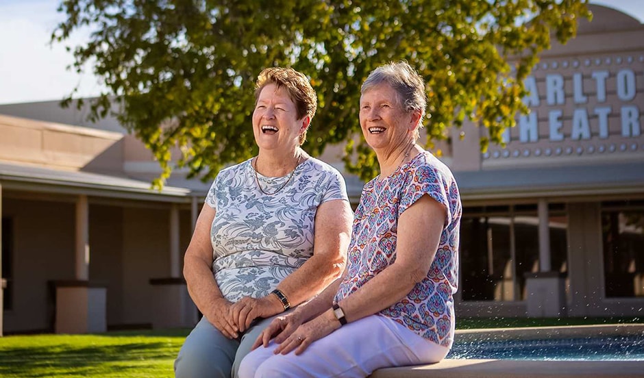 Sheena sitting with a friend at the Carlyle Gardens Townsville fountain