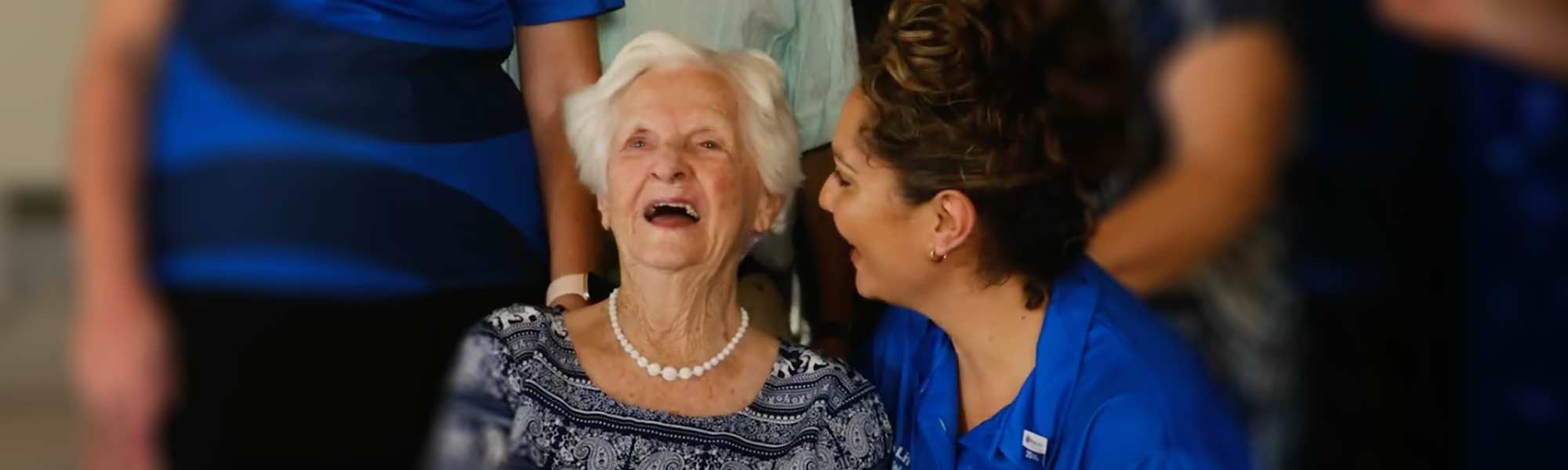 BlueCare resident Marjorie shares a laugh with staff member Margaret.