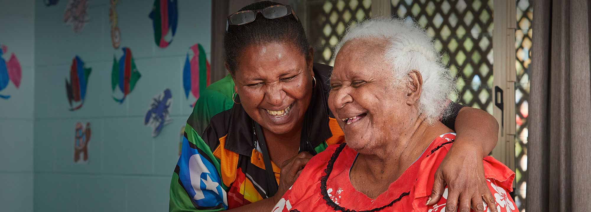 Two First Nations women have a chat in a common area of Pinangba Shalom Elders Village.